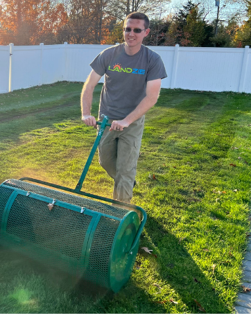 36 inch Landzie Tow Lawn Spreader spreading compost on lawn